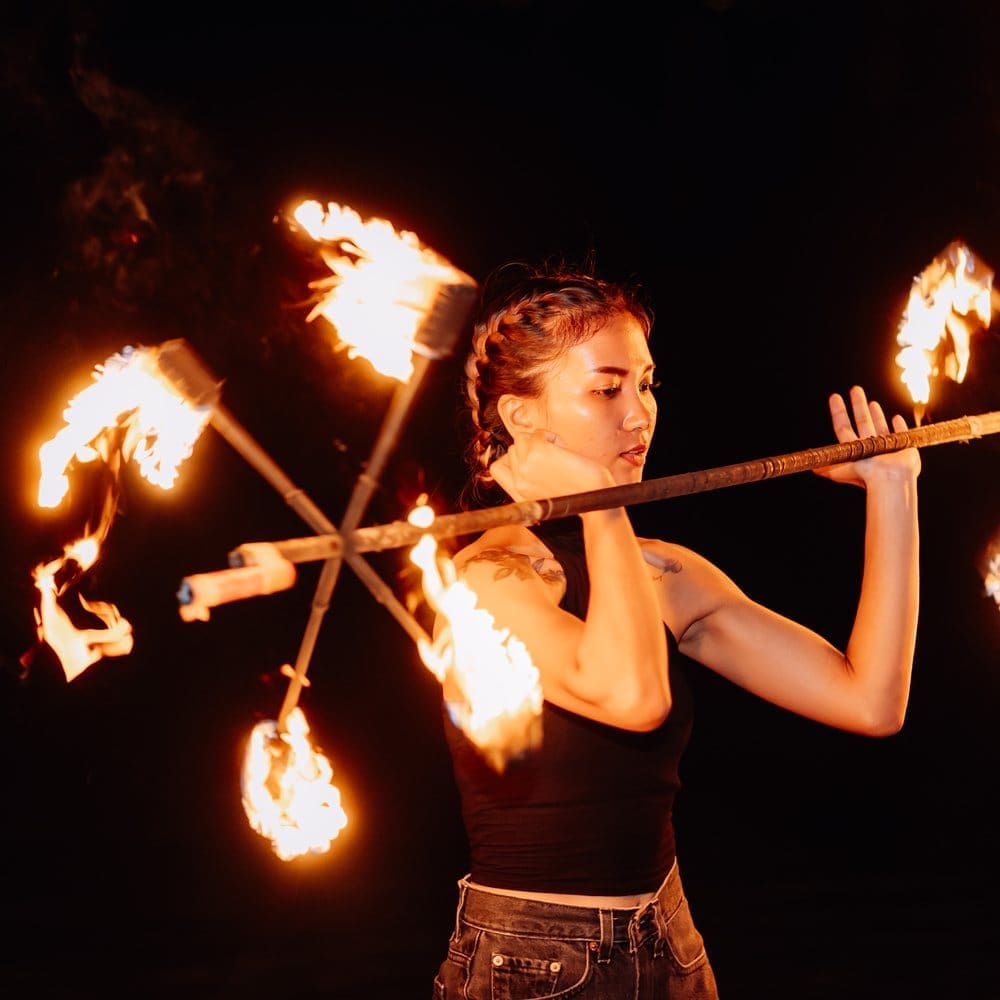 A fire performer on the sand at ARKbar at night